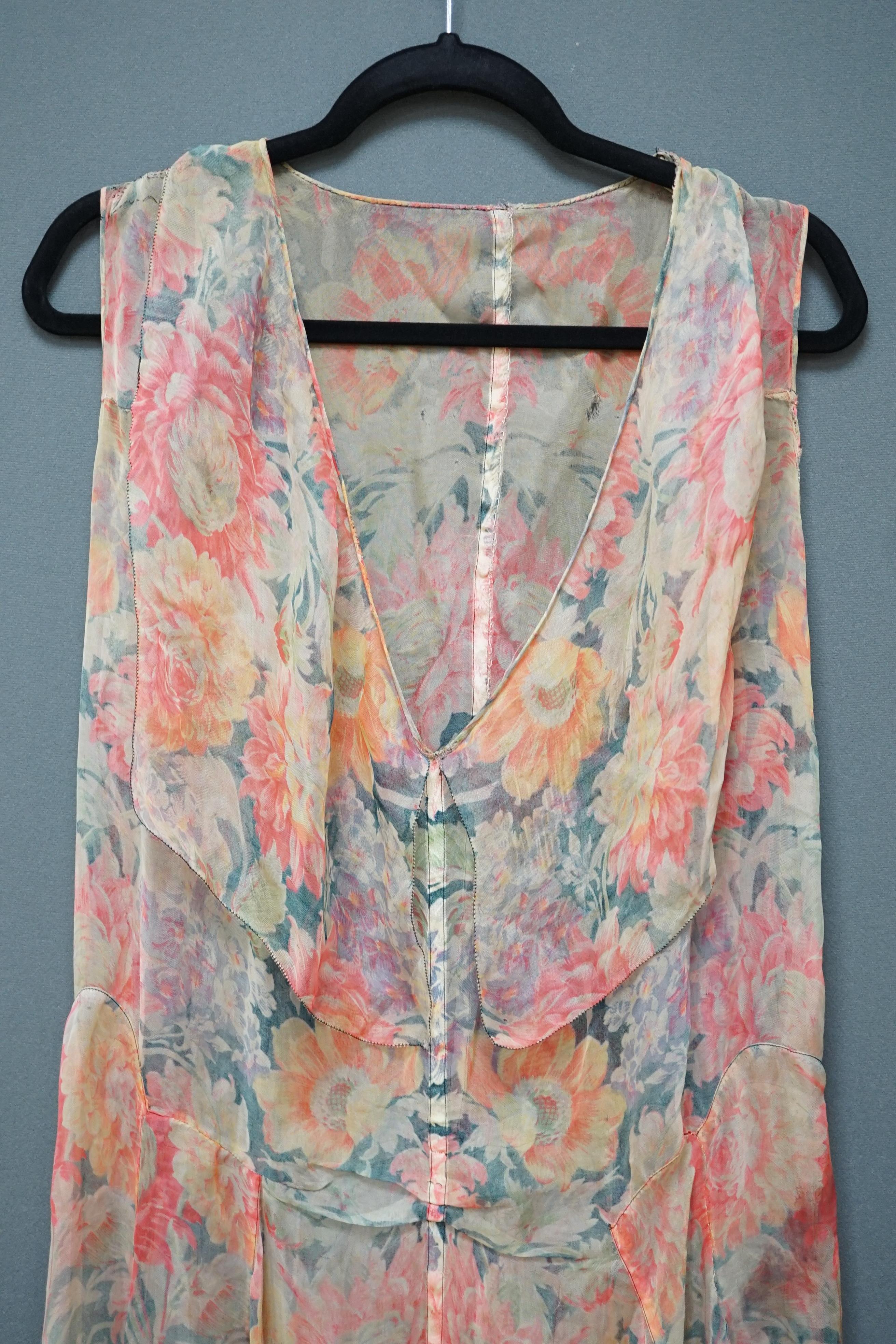 A 1930s printed sheer bias cut summer dress, hand made in a bright floral pattern silk organza style fabric, designed with a large collar and bias cut side panels. 42cm long from centre top back to hem. Condition - needs